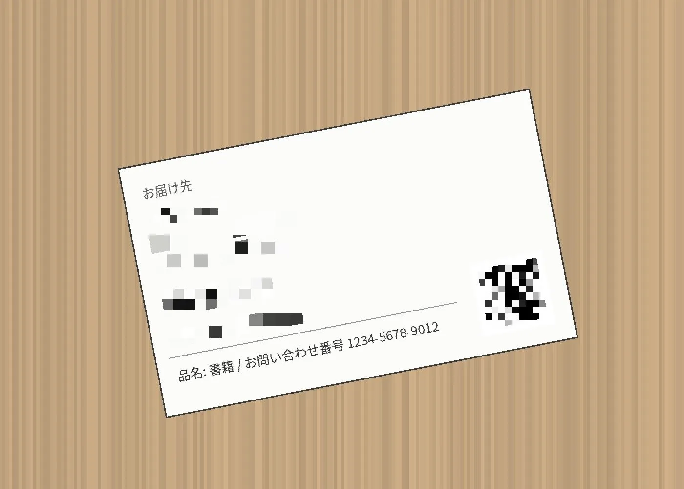 同じ宛名ラベルで住所・氏名・電話番号の行とQRコードにモザイクがかかった画像。モザイクがラベルの傾きに沿っている